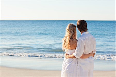 Back view of young couple standing at the beach Stock Photo - Premium Royalty-Free, Code: 6109-06003809