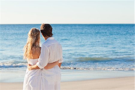 Back view of young couple watching the sea Stock Photo - Premium Royalty-Free, Code: 6109-06003810