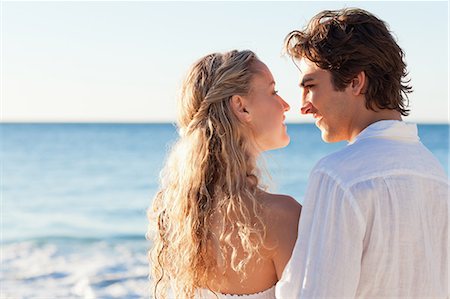 Back view of lovely young couple on the beach Stock Photo - Premium Royalty-Free, Code: 6109-06003814