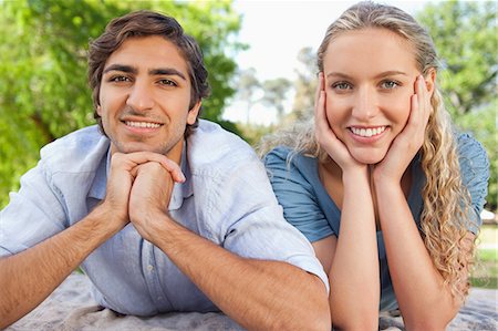 Happy young couple lying on the lawn together Stock Photo - Premium Royalty-Free, Code: 6109-06004459