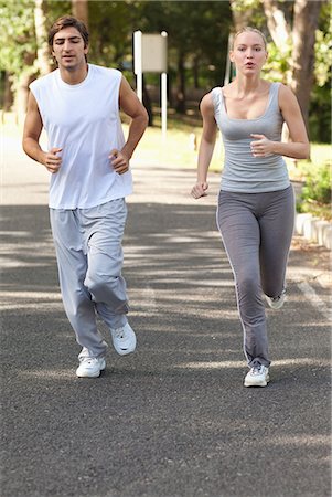 positive - Young sportspeople jogging on a countryside road Stock Photo - Premium Royalty-Free, Code: 6109-06004563