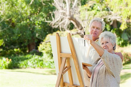 female artist painting at easel - Man and a woman painting on a canvas in a park Stock Photo - Premium Royalty-Free, Code: 6109-06004814