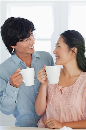 A smiling couple look into each others eyes as they have a drink Stock Photo - Premium Royalty-Free, Code: 6109-06004991