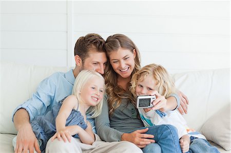 The family gather close to each other as they pose and smile for a beautiful family photo Stock Photo - Premium Royalty-Free, Code: 6109-06005067