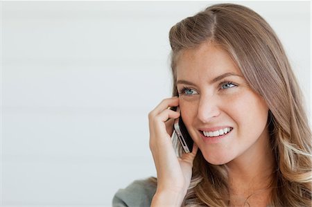 phone young caucasian woman relaxed - A close up shot of a woman with her head turned to the side as she chats Stock Photo - Premium Royalty-Free, Code: 6109-06005029