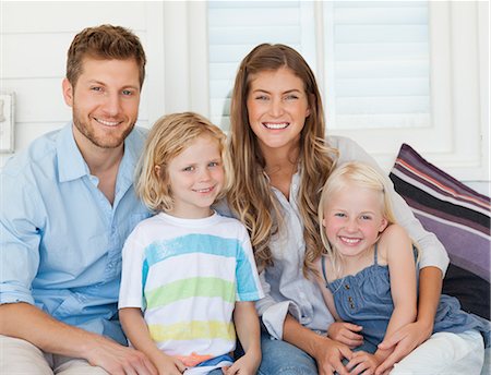 A close up shot of a smiling family all sitting together Stock Photo - Premium Royalty-Free, Code: 6109-06005167