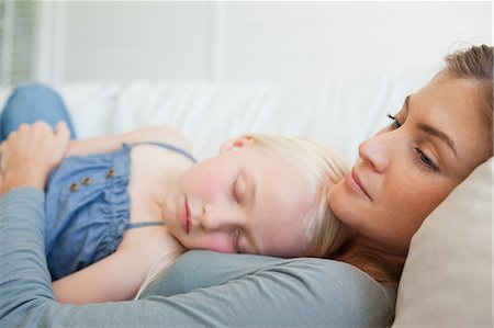 sleep sofa - A mother with her daughter asleep on her chest as they sleep on the couch Stock Photo - Premium Royalty-Free, Code: 6109-06005100