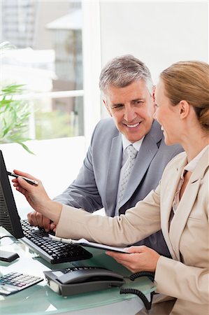simsearch:6109-06005290,k - Businessman working with a colleague in an office Stock Photo - Premium Royalty-Free, Code: 6109-06005248
