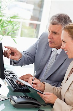 simsearch:6109-06005290,k - Businessman working with his secretary in an office Stock Photo - Premium Royalty-Free, Code: 6109-06005249