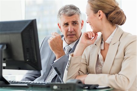 simsearch:6109-06005291,k - Business people talking in front of a computer in a office Stock Photo - Premium Royalty-Free, Code: 6109-06005265