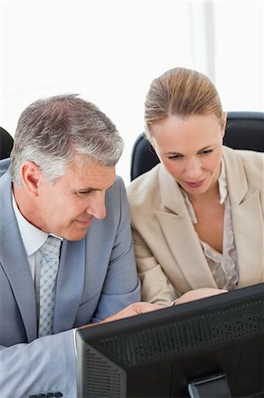 simsearch:6109-06005290,k - Business people with a computer in a office Stock Photo - Premium Royalty-Free, Code: 6109-06005270