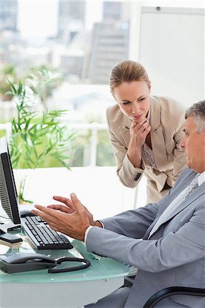 person helping someone with computer - Company people talking in a bright office Stock Photo - Premium Royalty-Free, Code: 6109-06005279