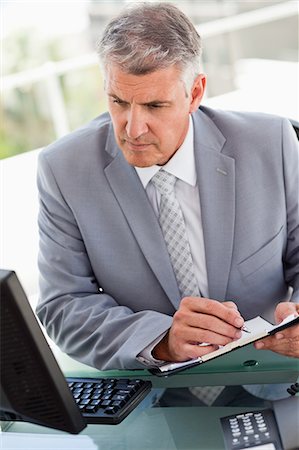 serious man in suit sitting - Businessman working in a brigh office Stock Photo - Premium Royalty-Free, Code: 6109-06005340