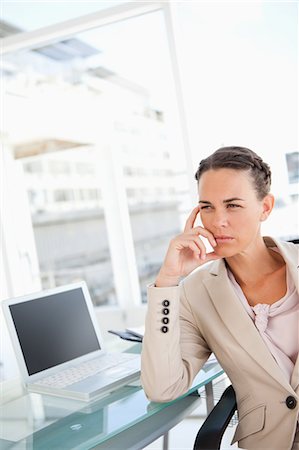 simsearch:6109-06005455,k - Thoughtful businesswoman in a beige suit in a bright office Fotografie stock - Premium Royalty-Free, Codice: 6109-06005451