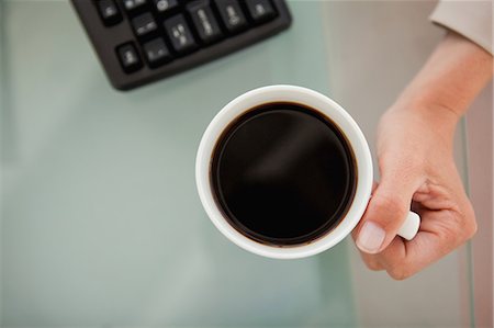 Close-up of a coffee with a high angle-shot taken by a woman Stock Photo - Premium Royalty-Free, Code: 6109-06005468