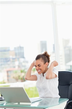 female computer laughing - Tanned businesswoman got a big promotion in a bright office Stock Photo - Premium Royalty-Free, Code: 6109-06005411
