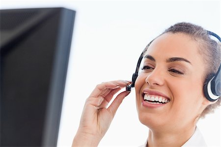 Close-up of a tanned businesswoman wearing a headset in a bright office Stock Photo - Premium Royalty-Free, Code: 6109-06005418