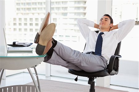 relaxed business man - Happy businessman feet on his desk in a bright office Stock Photo - Premium Royalty-Free, Code: 6109-06005563