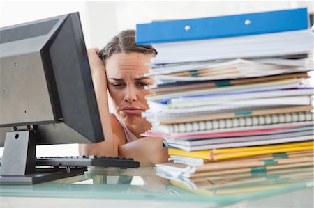 Discouraged businesswoman getting too much work in a bright office Foto de stock - Sin royalties Premium, Código: 6109-06005512