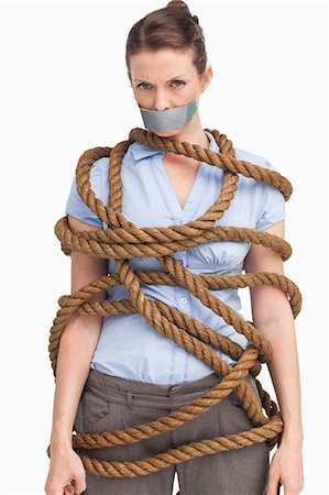 stress employees - Tied up businesswoman against a white background Stock Photo - Premium Royalty-Free, Code: 6109-06005679