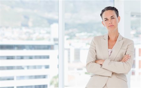 Serious saleswoman standing with folded arms Stock Photo - Premium Royalty-Free, Code: 6109-06005629