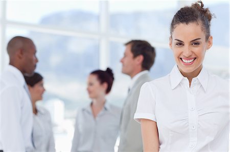 salesman - Smiling young tradeswoman with colleagues behind her Stock Photo - Premium Royalty-Free, Code: 6109-06005750