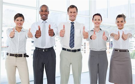 sales man in business suit - Smiling young businessteam giving thumbs up Stock Photo - Premium Royalty-Free, Code: 6109-06005757