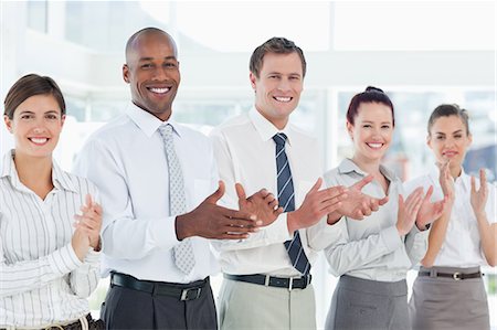 staff photo - Clapping young salesteam standing in a line Stock Photo - Premium Royalty-Free, Code: 6109-06005761