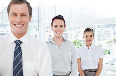 professional salesman - Smiling young tradespeople standing in a line Stock Photo - Premium Royalty-Free, Code: 6109-06005775