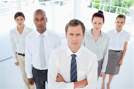 staff photo - Salesman with his arms folded standing with his team Stock Photo - Premium Royalty-Free, Code: 6109-06005779