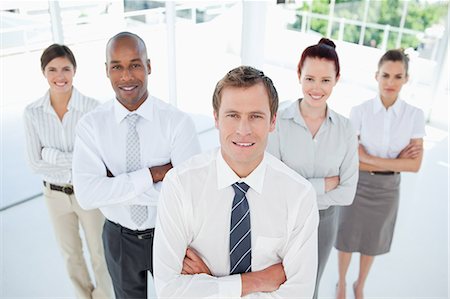 Salesteam with their arms crossed standing together Stock Photo - Premium Royalty-Free, Code: 6109-06005781