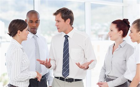 sales man in business suit - Salesman talking to his team members Stock Photo - Premium Royalty-Free, Code: 6109-06005792