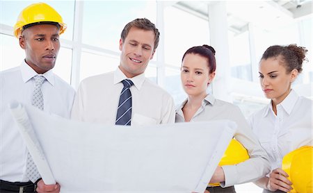 simsearch:6109-06005806,k - Team of young architects looking at a blueprint Stock Photo - Premium Royalty-Free, Code: 6109-06005794