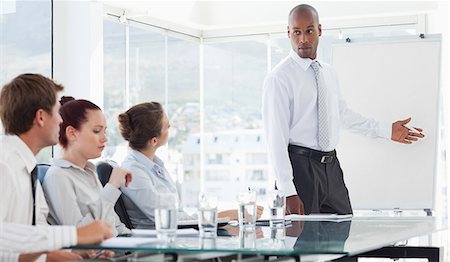 Young salesman using flip chart in his presentation Stock Photo - Premium Royalty-Free, Code: 6109-06005853