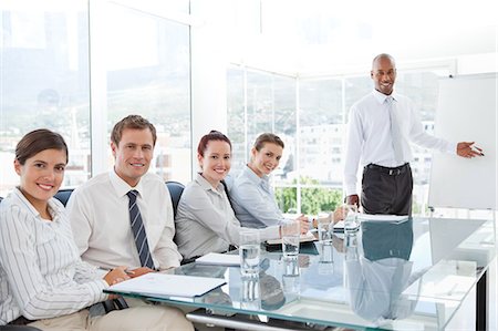 Young salesman giving a presentation for his colleagues Stock Photo - Premium Royalty-Free, Code: 6109-06005850