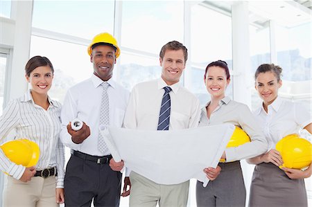 simsearch:6109-06005806,k - Smiling young architects standing together with a blueprint Stock Photo - Premium Royalty-Free, Code: 6109-06005800