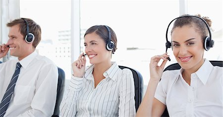 simsearch:6109-06005809,k - Smiling young call center agents sitting in a line Stock Photo - Premium Royalty-Free, Code: 6109-06005808