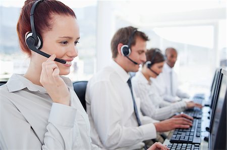 Young call center agents sitting in a line Stock Photo - Premium Royalty-Free, Code: 6109-06005810