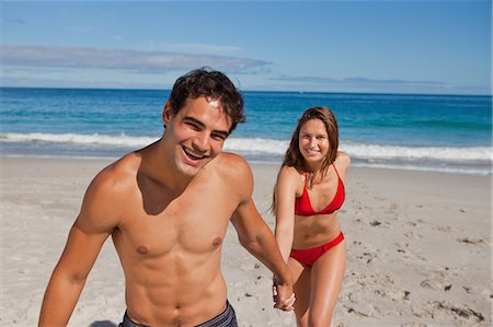 Portrait of a cheerful couple in swimsuit on the beach Stock Photo - Premium Royalty-Free, Code: 6109-06005949