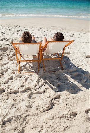 simsearch:6109-06195106,k - Rear view of a couple in folding chair in front of the sea Stock Photo - Premium Royalty-Free, Code: 6109-06006158