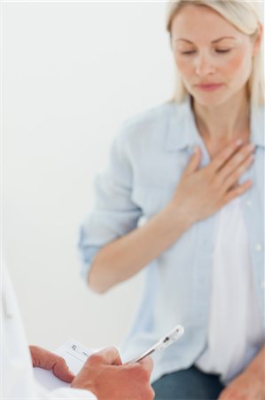 Doctor filling in a prescription for his female patient Stock Photo - Premium Royalty-Free, Code: 6109-06006387