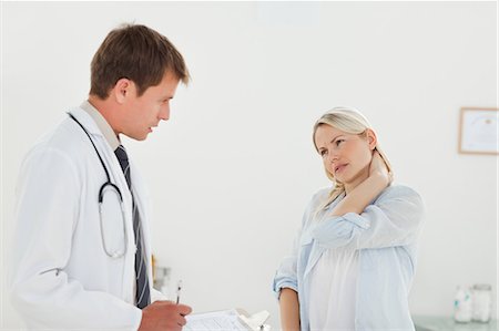 simsearch:6109-06006352,k - Young woman telling her doctor about her sore neck Foto de stock - Sin royalties Premium, Código: 6109-06006394