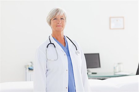 Mature doctor standing in her office Stock Photo - Premium Royalty-Free, Code: 6109-06006312