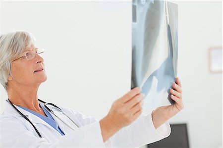 simsearch:6109-06006352,k - Side view of mature doctor looking at an x-ray Foto de stock - Sin royalties Premium, Código: 6109-06006334