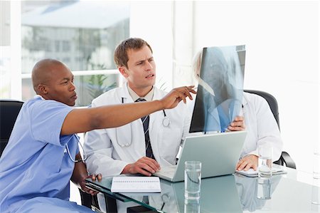 doctor business computer - Doctors together in meeting room analyzing x-ray Stock Photo - Premium Royalty-Free, Code: 6109-06006478