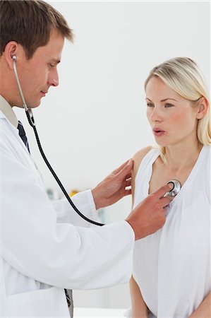 Male doctor checking patients heart beat Stock Photo - Premium Royalty-Free, Code: 6109-06006426