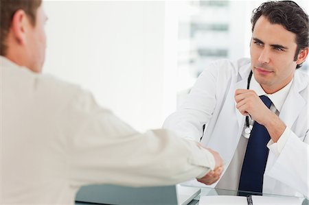 Young doctor shaking his patients hand Stock Photo - Premium Royalty-Free, Code: 6109-06006557