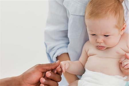 doctor and baby patient and mom - Male hand holding little babys hand Stock Photo - Premium Royalty-Free, Code: 6109-06006575