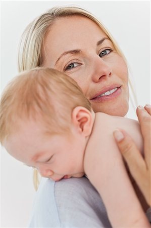 simsearch:6109-06006613,k - Smiling young mother holding her baby close Stock Photo - Premium Royalty-Free, Code: 6109-06006594