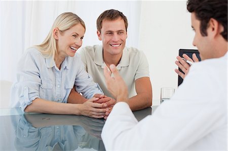 simsearch:6109-06006647,k - Cheerful couple seeing the doctor together Stock Photo - Premium Royalty-Free, Code: 6109-06006645